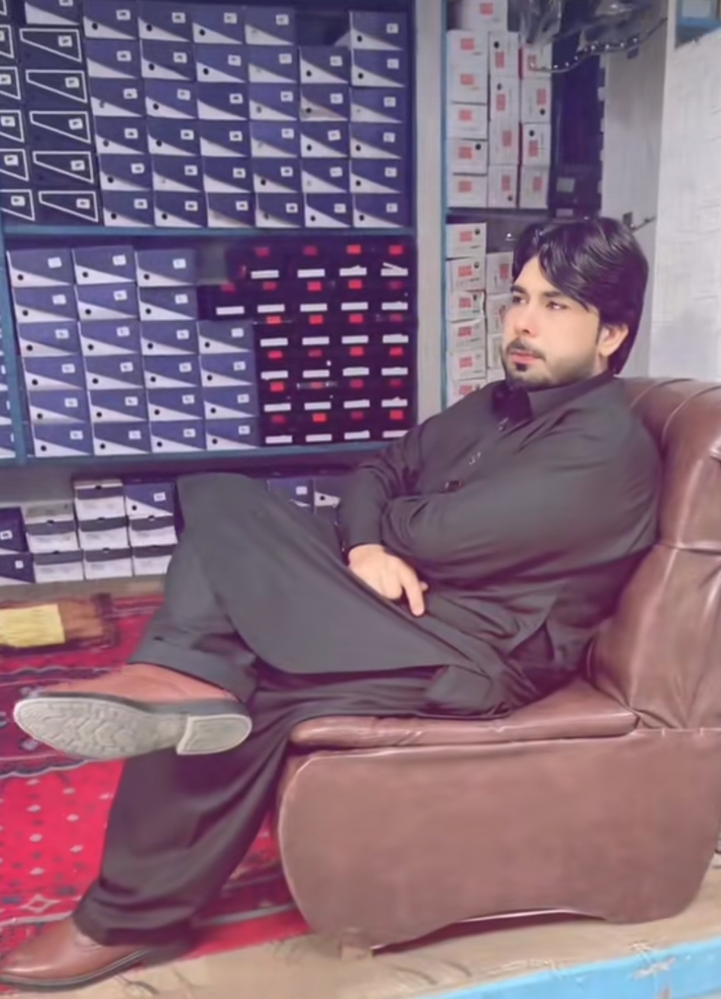 Anmol Corporation owner with floor-to-ceiling shoe inventory