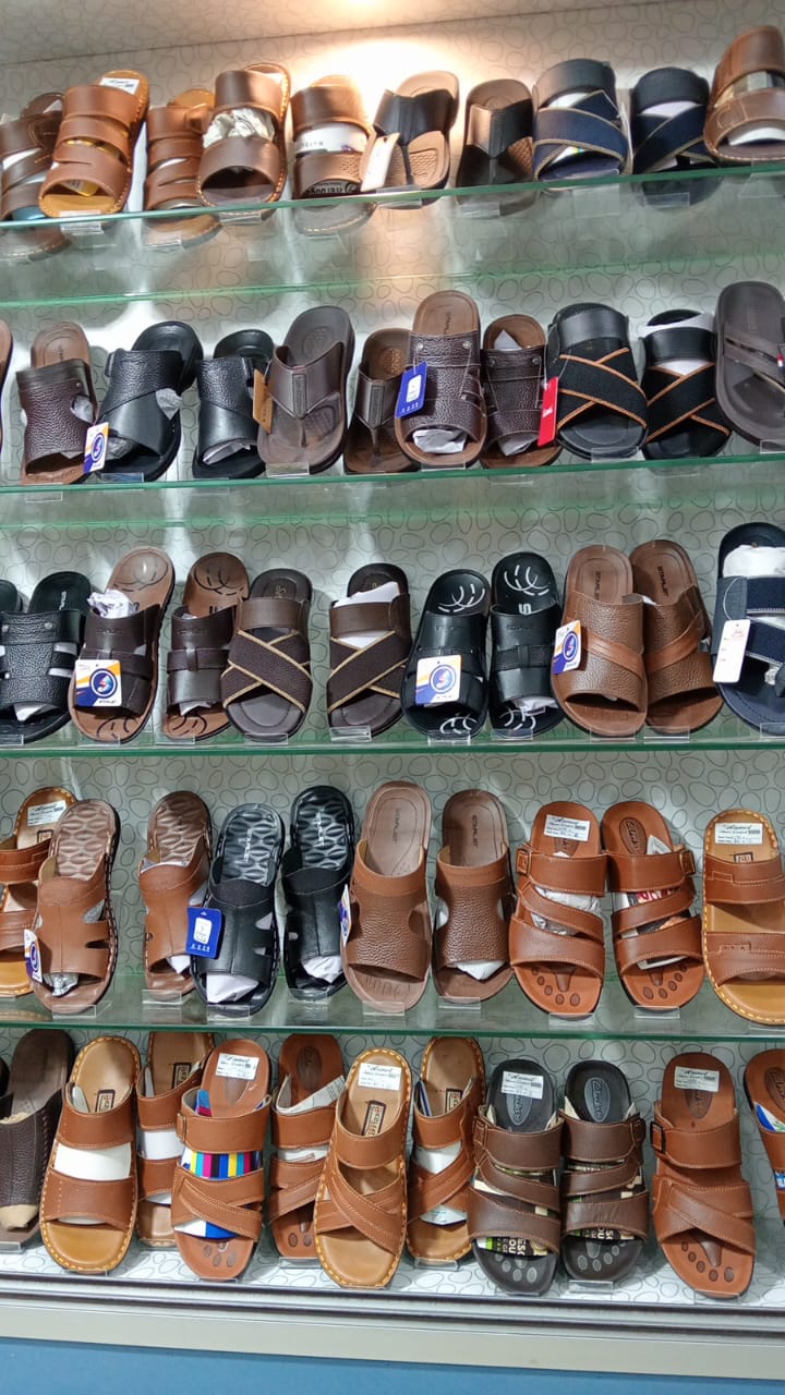 In-store leather sandals and slides wall — Clarks, Sk and more
